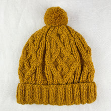 Mustard yellow handmade cable knit wool bobble hat with chunky ribbed cuff and pom pom detail