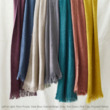 Hanging vegan banana yarn scarves in plum purple slate blue beige grey teal pink clay and mustard yellow