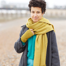 Close portrait of woman wearing mustard yellow banana yarn scarf