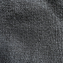 Close-up detail of black woven cotton fabric texture used in handmade boho shoulder tote bags