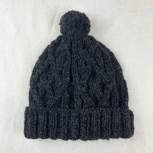 Dark grey wool bobble hat with cable knit texture and pom pom, hand-knitted from 100% sheep wool by fair trade artisans in Nepal