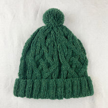 Forest green wool bobble hat with cable knit texture and pom pom, hand-knitted from 100% sheep wool by fair trade artisans in Nepal
