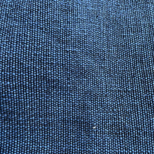 Detailed macro close-up of blue woven cotton fabric texture with artisan handcrafted weave pattern