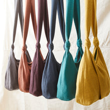 Handwoven cotton GYANI crossbody bags available in mustard yellow, terracotta brown, plum purple, navy blue, teal green and grey.