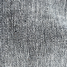 Close-up detail of grey woven cotton fabric showing artisan weave texture and natural fibre pattern