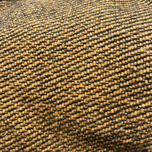 Close-up texture of mustard woven cotton fabric showing artisan weave detail and natural fibres