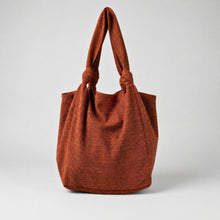 Handmade amber orange cotton tote bag with oversized slouchy shape and knotted shoulder straps