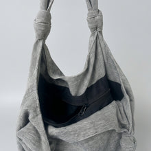 Interior view of handmade grey cotton shoulder bag featuring black lining and secure zip pocket