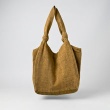 Handmade yellow cotton tote bag with soft slouchy shape and knotted shoulder straps on a neutral background