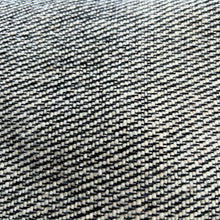 Close-up texture of grey woven cotton fabric showing artisan weave detail and natural fibres