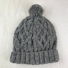 Light grey handmade wool bobble hat with cable knit texture and ribbed cuff crafted by fair trade artisans in Nepal