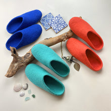 AURA QUE MITA felted wool slippers shown in blue, aqua and coral orange colourways.