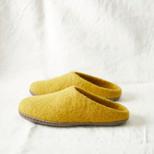 Mustard yellow felted wool slippers with slip-on mule shape and hardwearing suede soles.