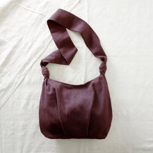 Plum purple handwoven cotton crossbody bag with soft slouchy shape and long comfortable strap.