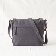 Back view of handmade grey canvas messenger bag featuring secure rear zip pocket and adjustable strap.