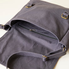 Interior detail of grey handmade canvas satchel featuring secure zip pocket and spacious compartment.