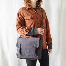 Woman wearing handmade grey canvas satchel crossbody bag with casual sustainable fashion styling.