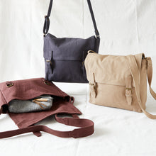 Collection of handmade canvas satchel bags in grey, beige and brown with adjustable shoulder straps.