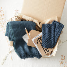 Luxury gift box featuring a blue banana yarn scarf, hand knit wrist warmers, eco packaging and artisan winter accessories.