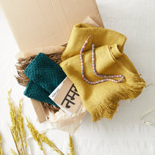 Mustard yellow vegan banana yarn scarf styled as a thoughtful handmade gift